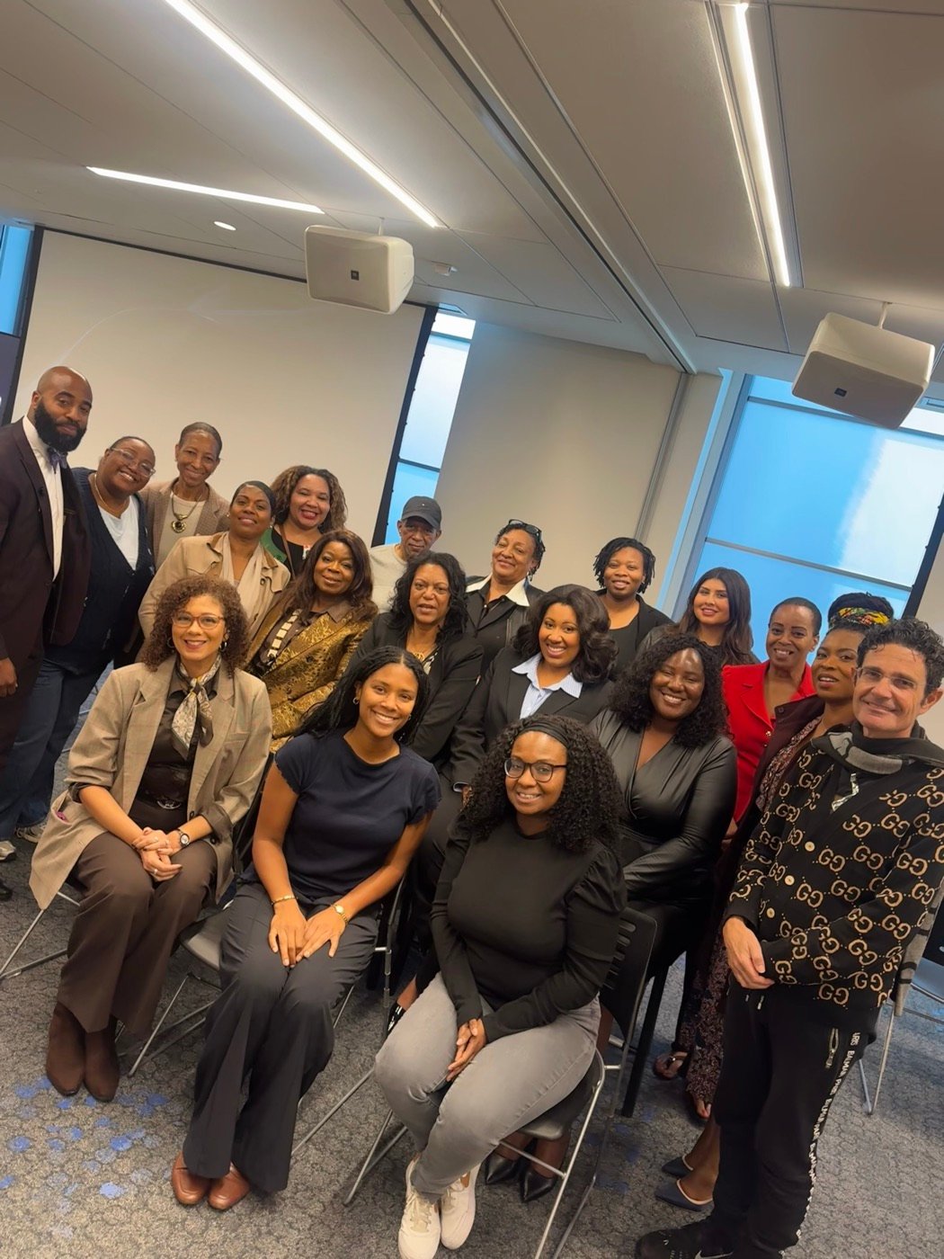 Large group of professionals posing together in a conference room