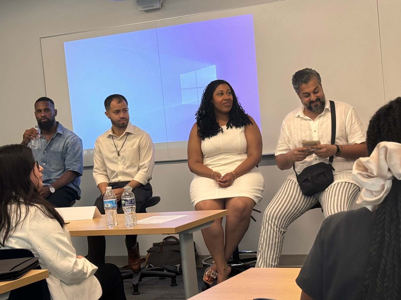 Myettia speaking on an industry panel in front of an audience